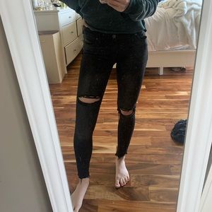 Black mid-waisted Free People ripped jeans.